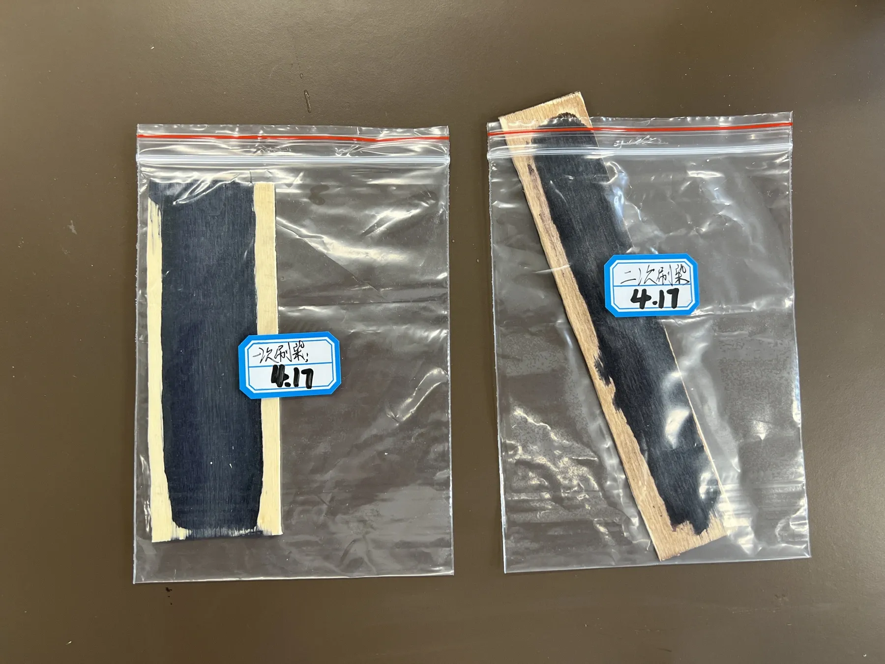 Original dark processed wooden samples in labelled bags